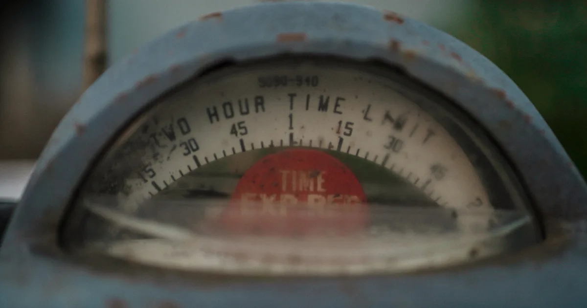 Vintage parking meter dial with a red TIME EXPIRED flag
